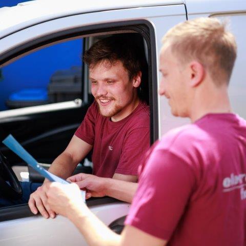 2 Personen schauen lächelnd etwas an 